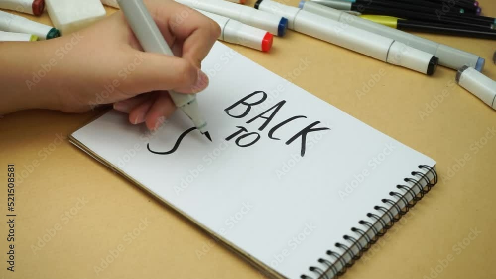 Back to school, the girl wrote in a notebook with a black marker