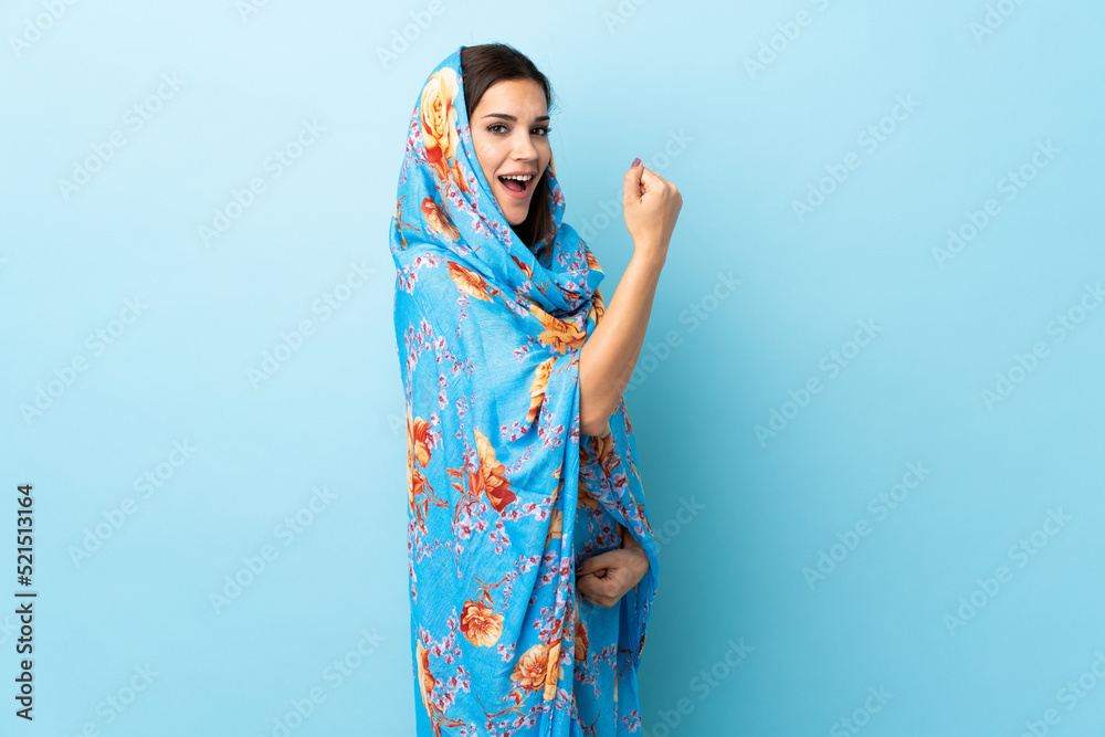 Young Moroccan woman with traditional costume isolated on blue background celebrating a victory Young Moroccan woman with traditional costume isolated on blue background celebrating a victory
