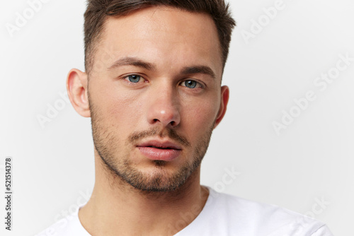 Sad frustrated unhappy tanned handsome man in basic t-shirt tired of problems look at camera posing isolated on white studio background. Copy space Banner Mockup. People emotions Lifestyle concept