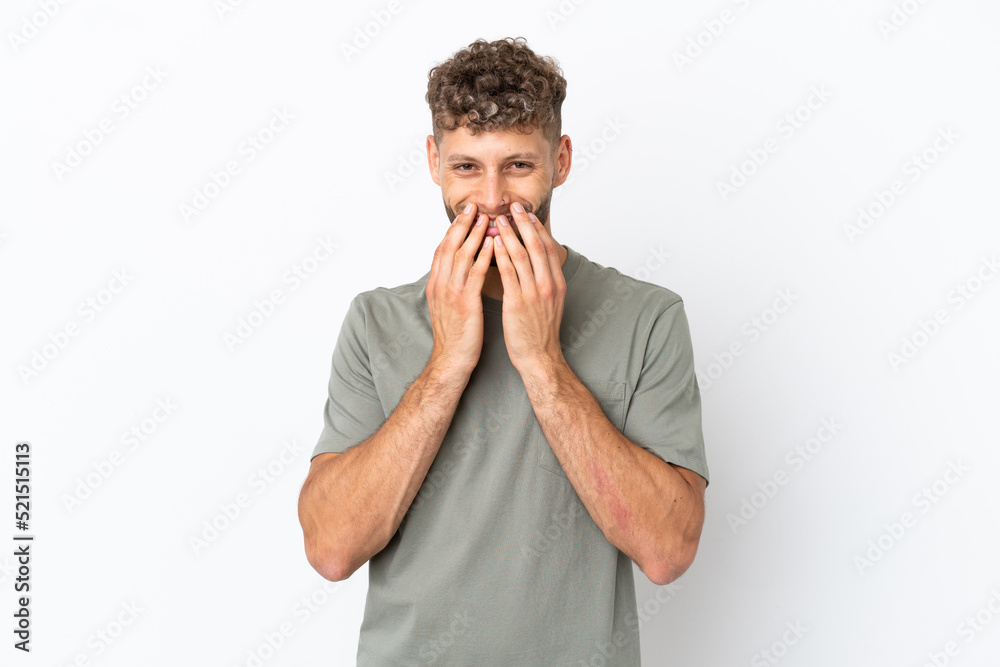 Young caucasian handsome man isolated on white background happy and smiling covering mouth with hands Young caucasian handsome man isolated on white background happy and smiling covering mouth with hands