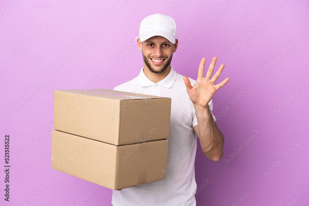 Delivery caucasian man isolated on purple background counting five with fingers Delivery caucasian man isolated on purple background counting five with fingers