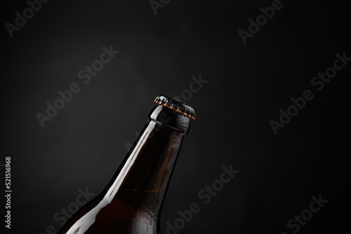 close up photo of beer bottle on black background
