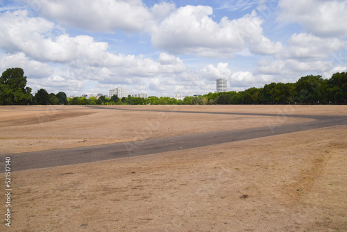 Parched landscape in Hyde Park in London, UK due to hot weather and drought conditions caused by climate change.
