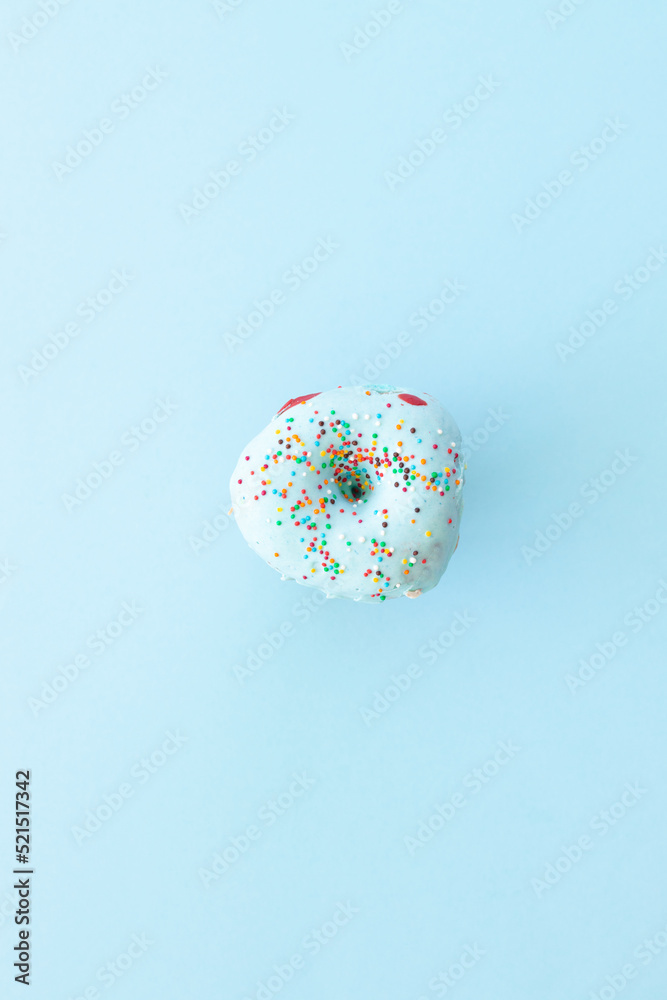 Sprinkled blue donuts on blue background