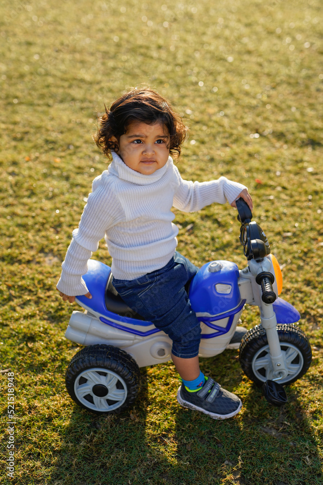 indian child playing in the garden indian child playing in the garden