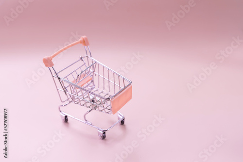 toy shopping cart isolated on white. watch in the shopping cart, lack of time, waste of time, shopping time.Trolley and money. Financial crisis or shopaholic concept.Buying and selling
