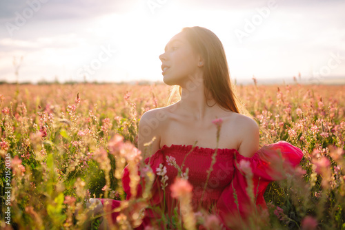 Happy woman in the blooming  field. Nature, fashion, vacation and lifestyle.