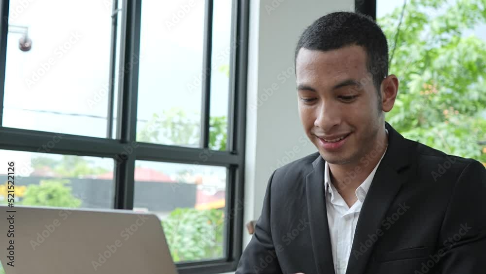 Young businessman talking through a laptop