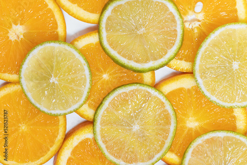 round slices of juicy orange and lime. background for your design