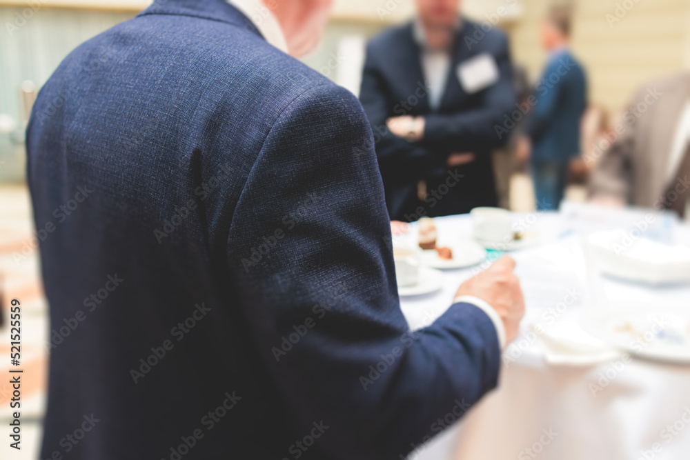 Group of men in business suits talking and discussing during coffee break at conference, politicians and entrepreneurs networking and negotiate, businessmen have a conversation