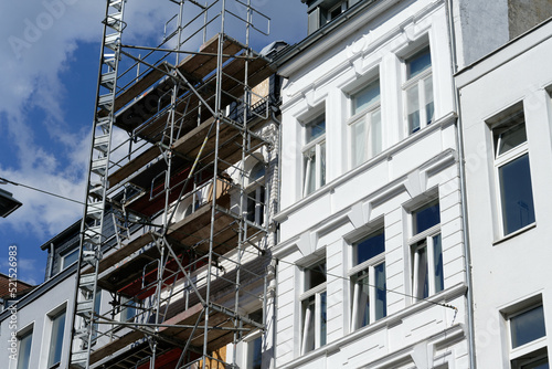 building renovation renovated and scaffolded not renovated old building