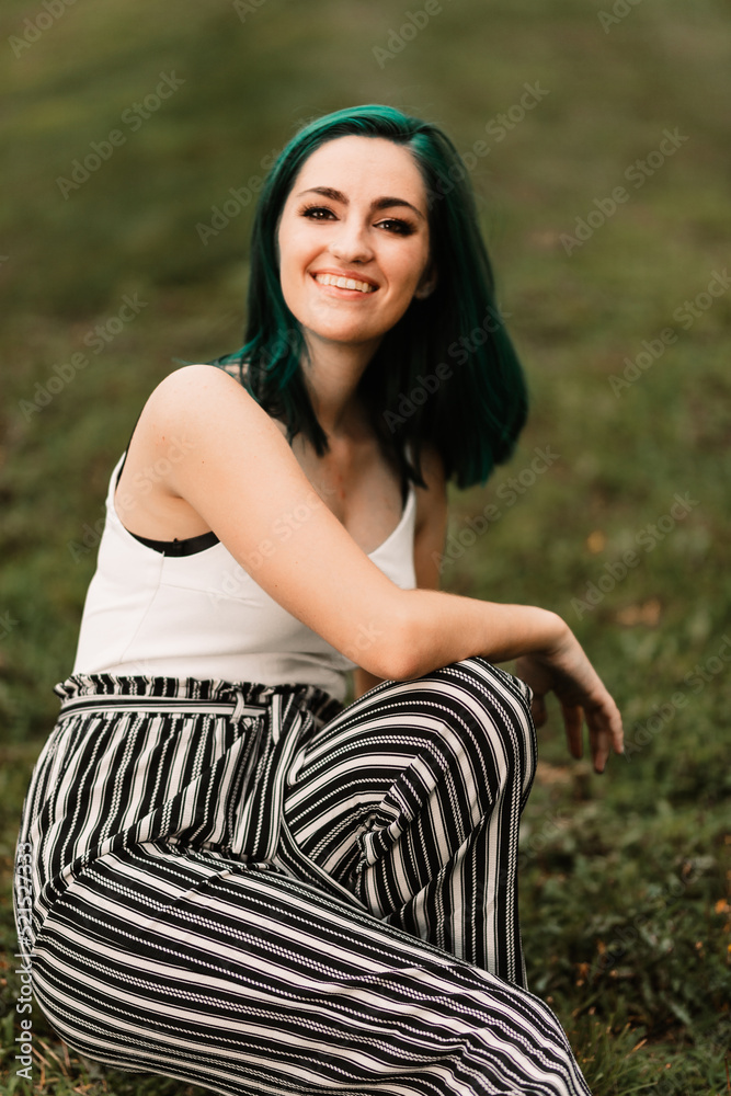 Girl with green hair sitting in the grass Girl with green hair sitting in the grass