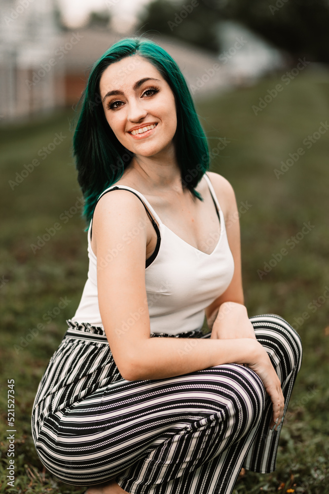 Girl with green hair sitting in the grass Girl with green hair sitting in the grass