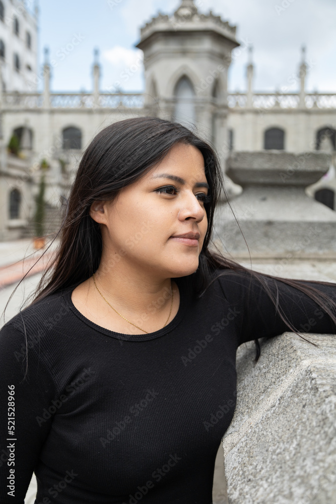 face of beautiful young latin woman with long straight hair, tourist in tourist place of the city in the day, beauty and architecture