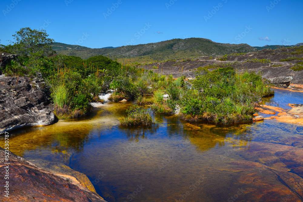 Wading on the shallow natural pools and rocky riverbed of Rio do Lajeado river, Milho Verde, Minas Gerais state, Brazil
