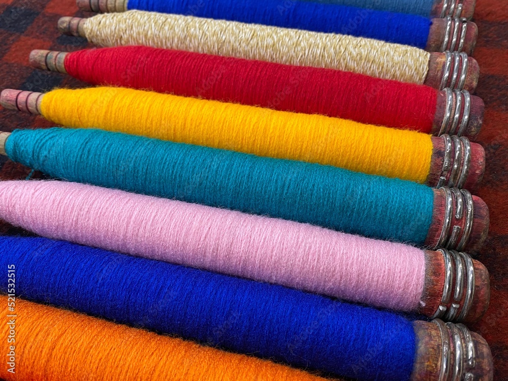 Colorful threads. Yarn. Bobbins with yarn. Fabric. Sewing threads. Skein of thread. Texture of colorful thread in spoolls. Colorful threads. Yarn. Bobbins with yarn. Fabric. Sewing threads. Skein of thread. Texture of colorful thread in spoolls.