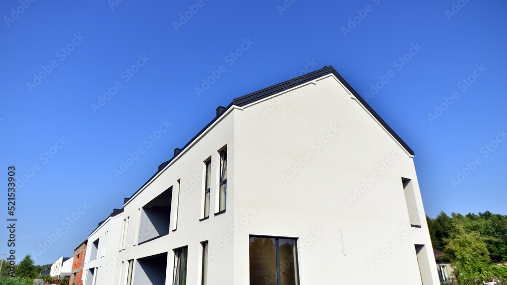 Terraced family home in newly developed housing estate. The real estate market in the suburbs. Terraced family home in newly developed housing estate. The real estate market in the suburbs.