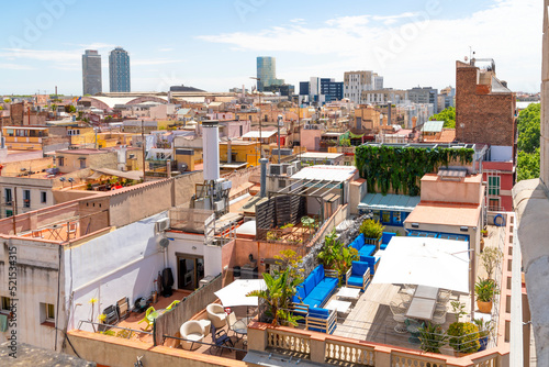 View from the rooftop terrace of the Basilica de Santa Maria del Pi overlooking the skyline, El Born and Ribera districts, with many rooftop home and apartment patios.