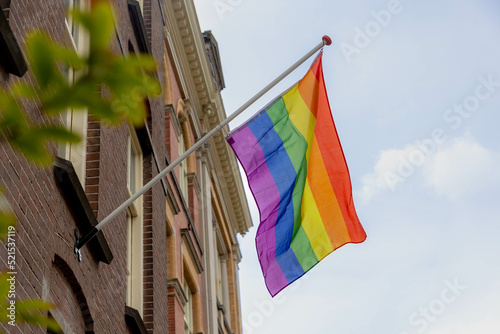 Canvas Print Celebration of pride month in Amsterdam, Rainbow flag hanging outside building along street, Symbol of Gay, Lesbian, Bisexual and Transgender, LGBT community in Holland, Social movements, Netherlands