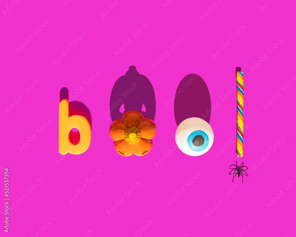 Halloween boo concept. Scary pumpkin, eye ball, candy and spider on pink background. Minimalistic holiday composition. Halloween boo concept. Scary pumpkin, eye ball, candy and spider on pink background. Minimalistic holiday composition.