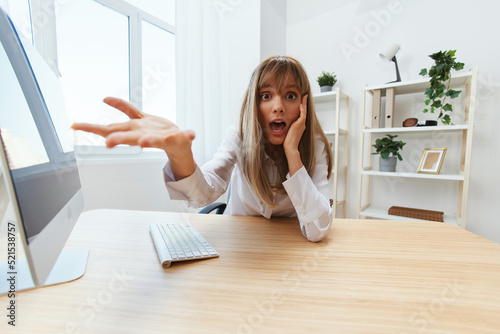 Shocked upset adorable blonde businesswoman worker made a critical mistake opening mouth think of problem solution recline on hand spread hand at camera in light office. Copy space, wide angle
