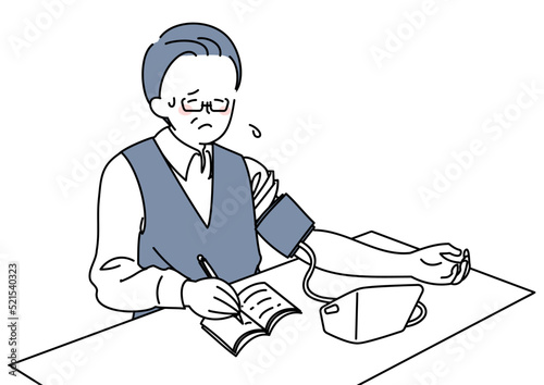 血圧を計り記録する男性