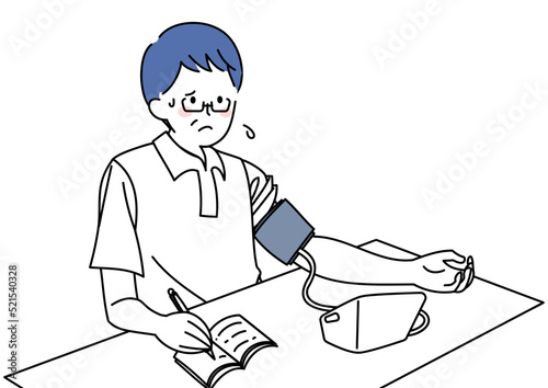 血圧を計り記録する男性