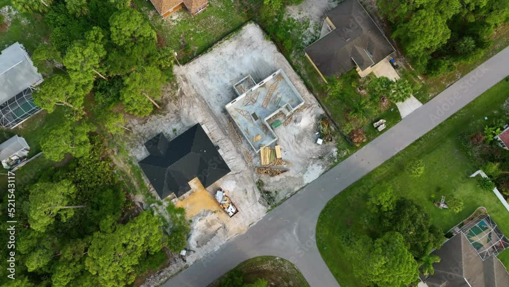 Aerial view of incompleted frame of private home under construction with brick concrete walls ready for installation of wooden roofing beams. Industrial building site Aerial view of incompleted frame of private home under construction with brick concrete walls ready for installation of wooden roofing beams. Industrial building site