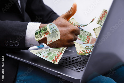 500 Azerbaijani manat notes coming out of laptop with Business man giving thumbs up, Financial concept. Make money on the Internet, working with a laptop