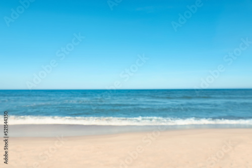 Blurred view of beautiful sea and sandy beach on sunny day © New Africa