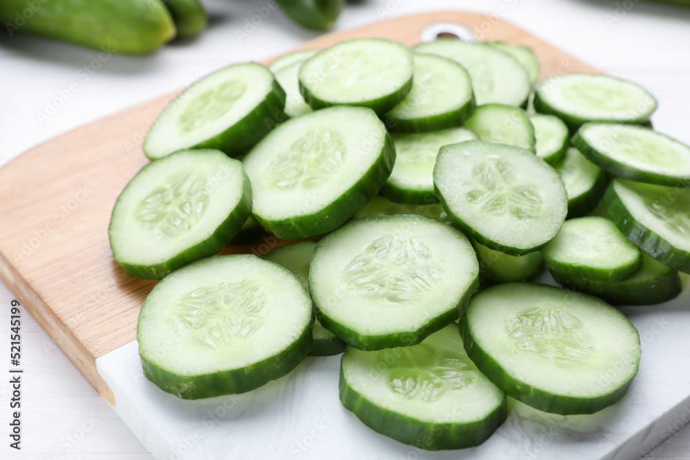 Slices of fresh ripe cucumber on board, closeup Slices of fresh ripe cucumber on board, closeup