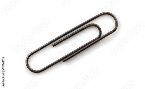 Old rusted paper clip, isolated on white, with natural shadows.