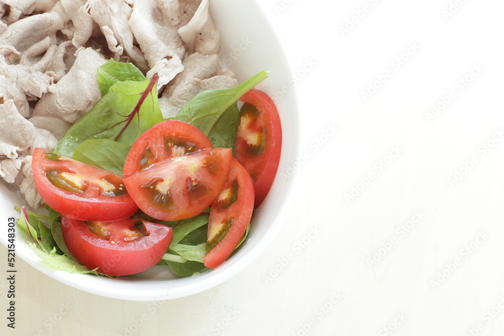 Japanese summer food, boiled pork slices served with baby leaves and cherry tomato Japanese summer food, boiled pork slices served with baby leaves and cherry tomato