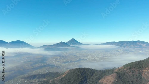 Vista aérea de Xela Quetzaltenango sobre las nubes y Vollcán Santa María como destino turístico photo