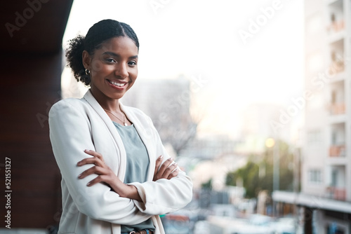 Принти на полотні Young, confident and ambitious business woman standing arms crossed on a balcony outside in the city