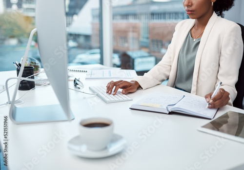 Writing notes, typing on a computer and working at her desk with a corporate and professional business woman. Manager, boss or CEO scheduling appointments in her diary and planning for the future