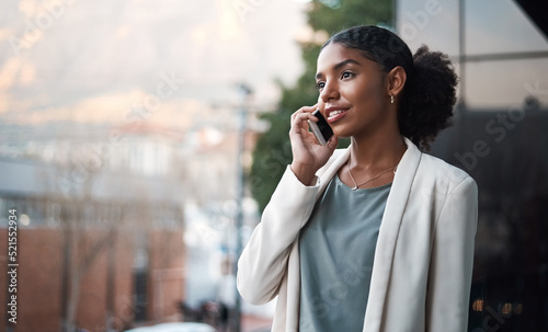 Talking on a phone, communication and networking with a young, confident and ambitious young business woman on a balcony. Professional and creative designer on a call for work discussion and planning