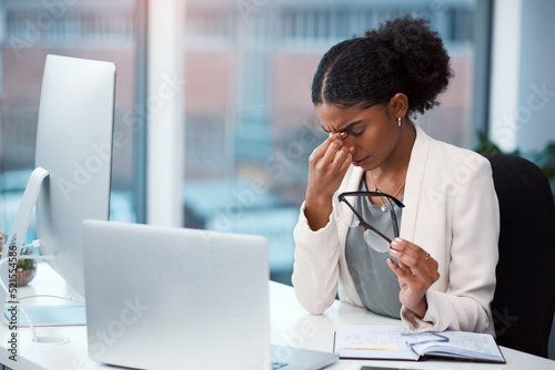 Stressed, tired and frustrated businesswoman with headache, eye strain and burnout making mistake on office laptop. Overworked creative entrepreneur failing to meet deadline or plan startup strategy photo