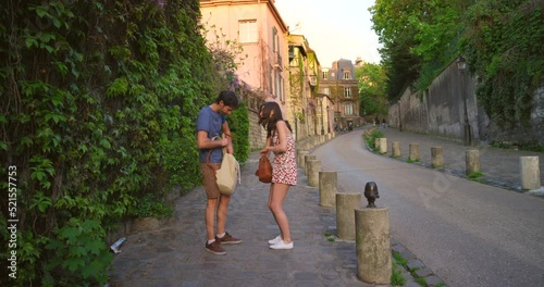 Stressed, lost and in a panic as tourists check their backpacks looking for missing passport or stolen wallet and becomes victim of theft and pickpocket crime. Frustrated couple argue on city street photo