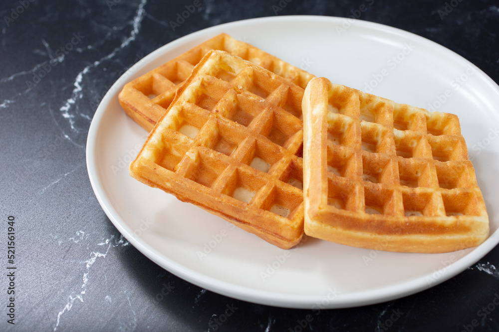 A view of a plate of waffles. A view of a plate of waffles.