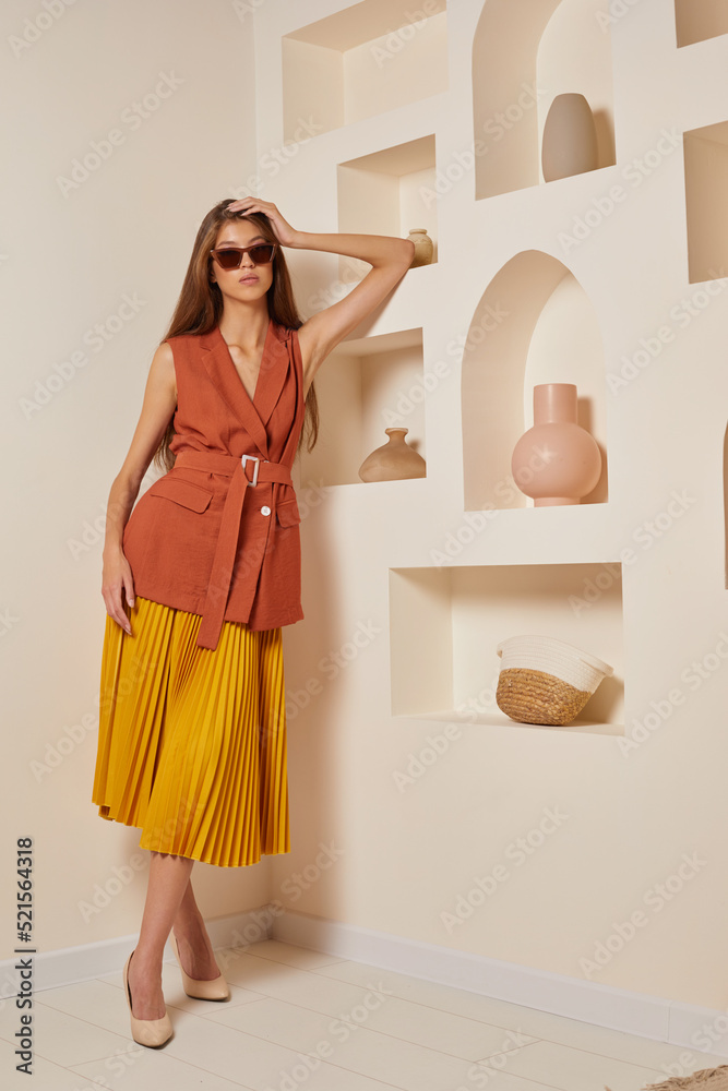 Young asian woman in brown jacket and yellow skirt. Young asian woman in brown jacket and yellow skirt.