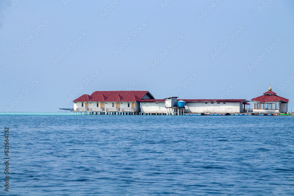 A floating house made of wooden planks in the middle of the sea