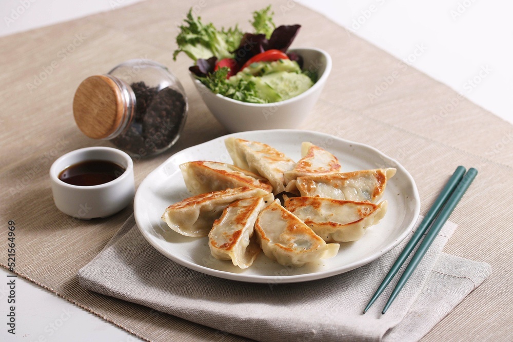 Modern Style grilled gyoza or dumplings snack with soy sauce