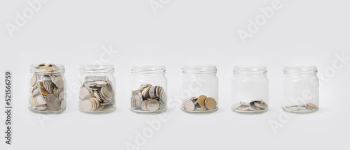 Glass jars with coins.Concept background for business,finance,.savings.Color toned in clean pastel.