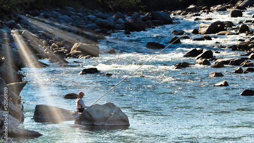 Ayu fishing angler in the rural river (summer vacation in the countryside) photo