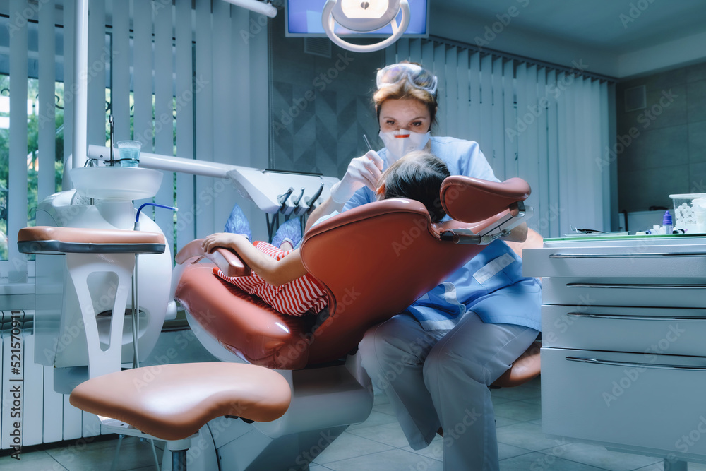 young girl patient sitting on chair in dental office. Child in the dental chair, dental