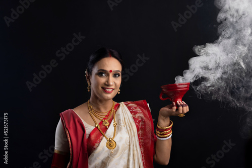 Canvas Print Portrait of Bengali woman holding a dhunuchi