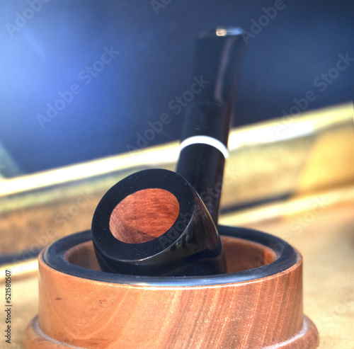 dark smoking pipe with briar stove in the wooden container