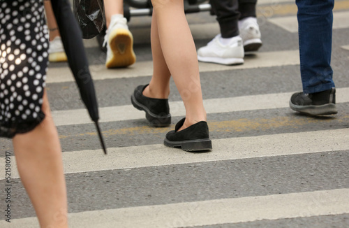 Legs of people walking on a pedestrian crossing © schankz