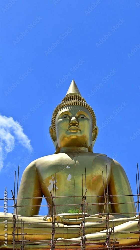 Fototapeta premium Buddha image of Luang Por Sothon, Wat Bosoth, on August 4, 2022, at Wat Bosoth, Sam Khok, Pathum Thani Province. Vertical image from the front